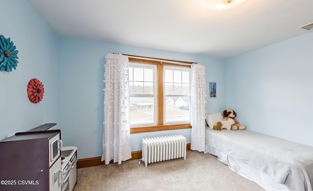 bedroom with baseboards, radiator heating unit, visible vents, and carpet flooring