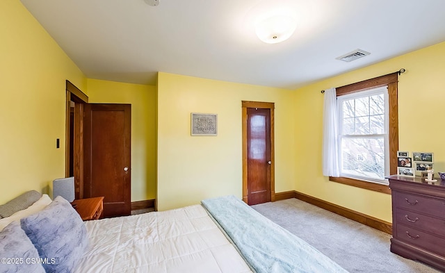 carpeted bedroom with baseboards and visible vents