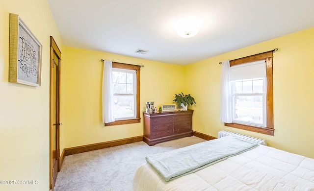 carpeted bedroom with visible vents and baseboards