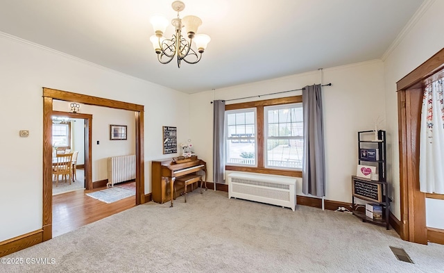 misc room with radiator, carpet, visible vents, and a wealth of natural light