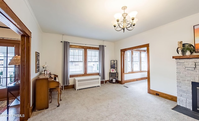 living area featuring radiator, crown molding, a fireplace, and a wealth of natural light