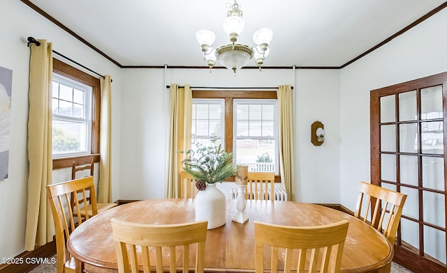 dining space with a chandelier and ornamental molding