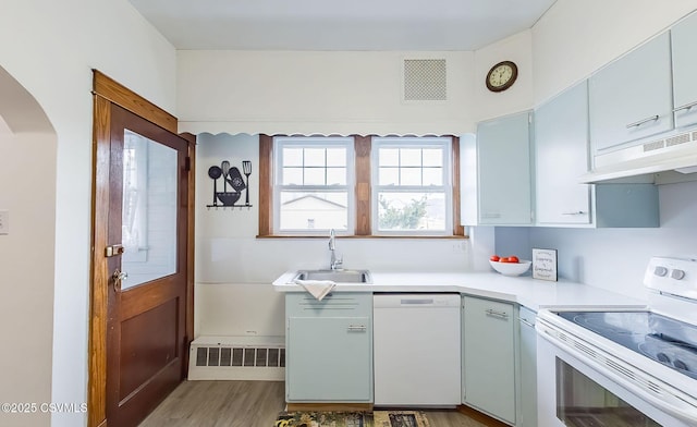 kitchen with white appliances, visible vents, a sink, and under cabinet range hood