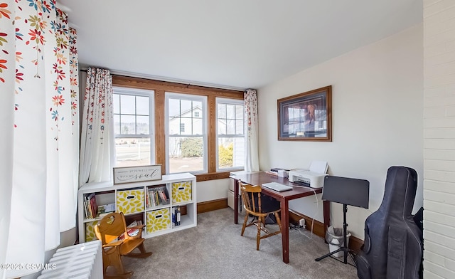 carpeted office space featuring baseboards