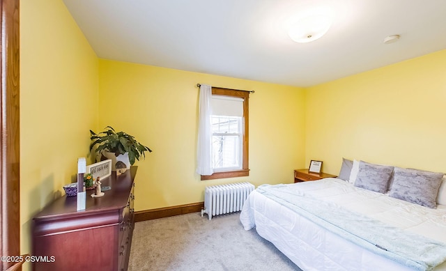 bedroom with baseboards, carpet flooring, and radiator