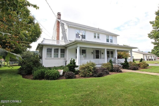 country-style home featuring covered porch, a chimney, and a front yard