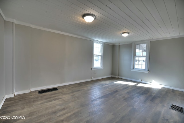 unfurnished room with ornamental molding, dark wood-style flooring, and visible vents