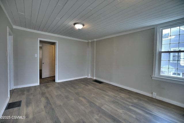 spare room with ornamental molding, dark wood-style flooring, and visible vents