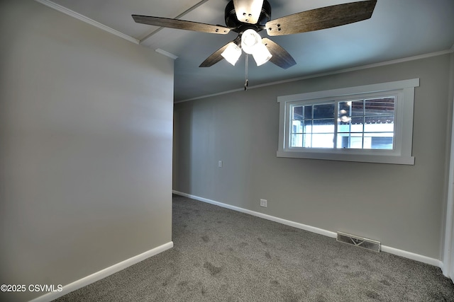 carpeted empty room featuring baseboards, visible vents, ceiling fan, and crown molding