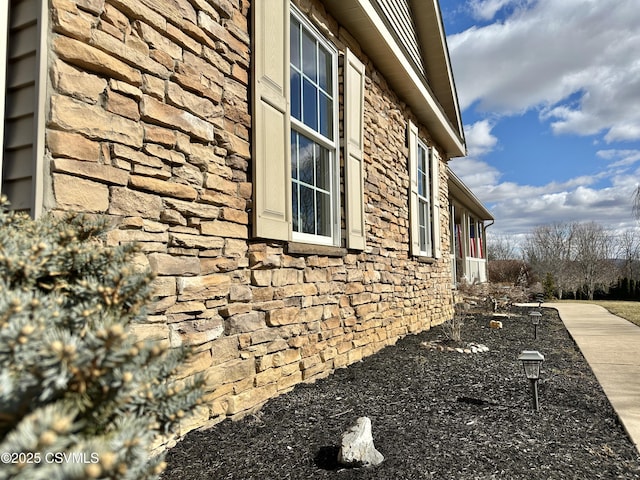 view of side of property featuring stone siding