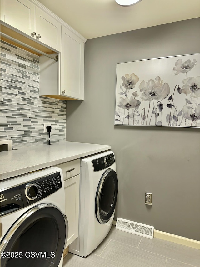 laundry room featuring cabinet space, baseboards, visible vents, and independent washer and dryer