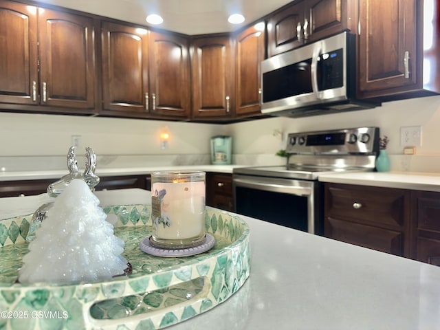 kitchen with appliances with stainless steel finishes and light countertops