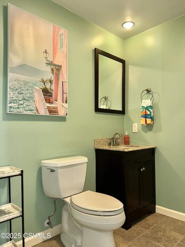 bathroom featuring visible vents, vanity, toilet, and baseboards