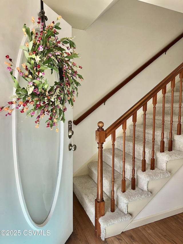 staircase with wood finished floors