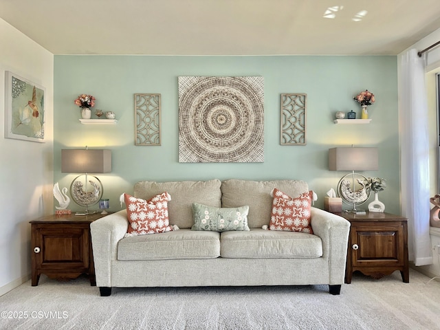 living area featuring carpet flooring and baseboards