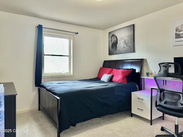 bedroom featuring light carpet and baseboards