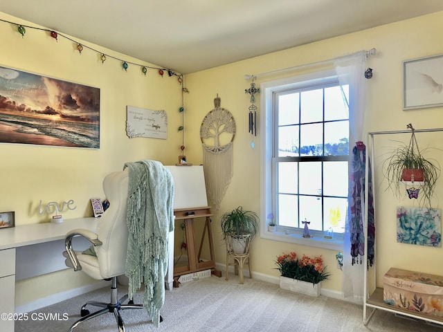 carpeted home office featuring baseboards