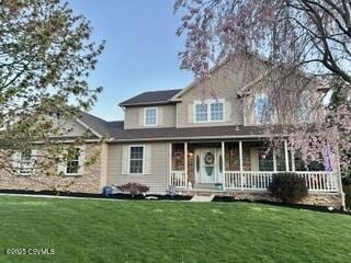 view of front of property with a porch and a front lawn