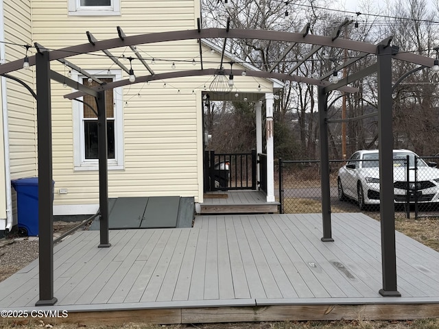 wooden deck featuring fence and a pergola