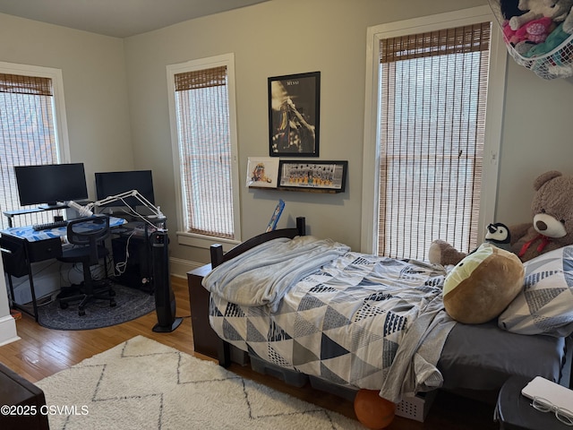 bedroom featuring baseboards and wood finished floors