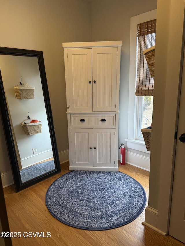 interior space featuring wood finished floors and baseboards