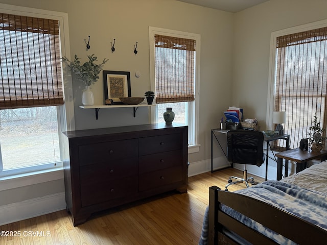 bedroom with light wood-style floors and baseboards