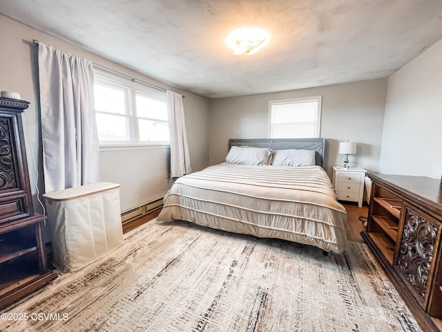 bedroom featuring a baseboard radiator and wood finished floors