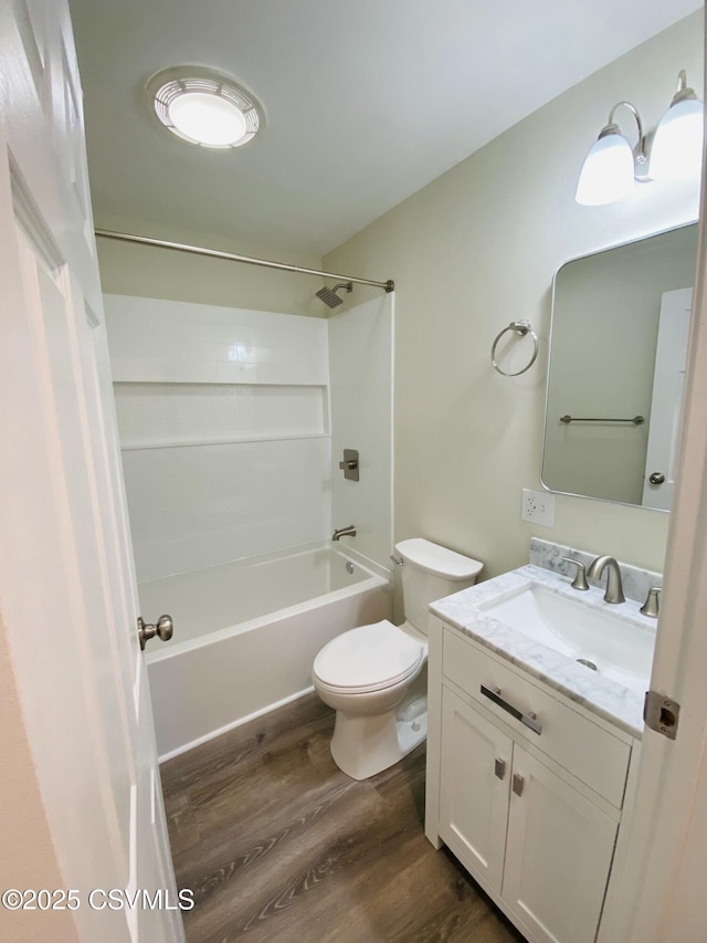 bathroom featuring shower / bath combination, vanity, toilet, and wood finished floors