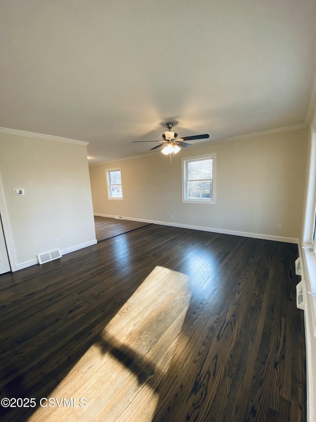 unfurnished room featuring visible vents, baseboards, a ceiling fan, dark wood finished floors, and crown molding