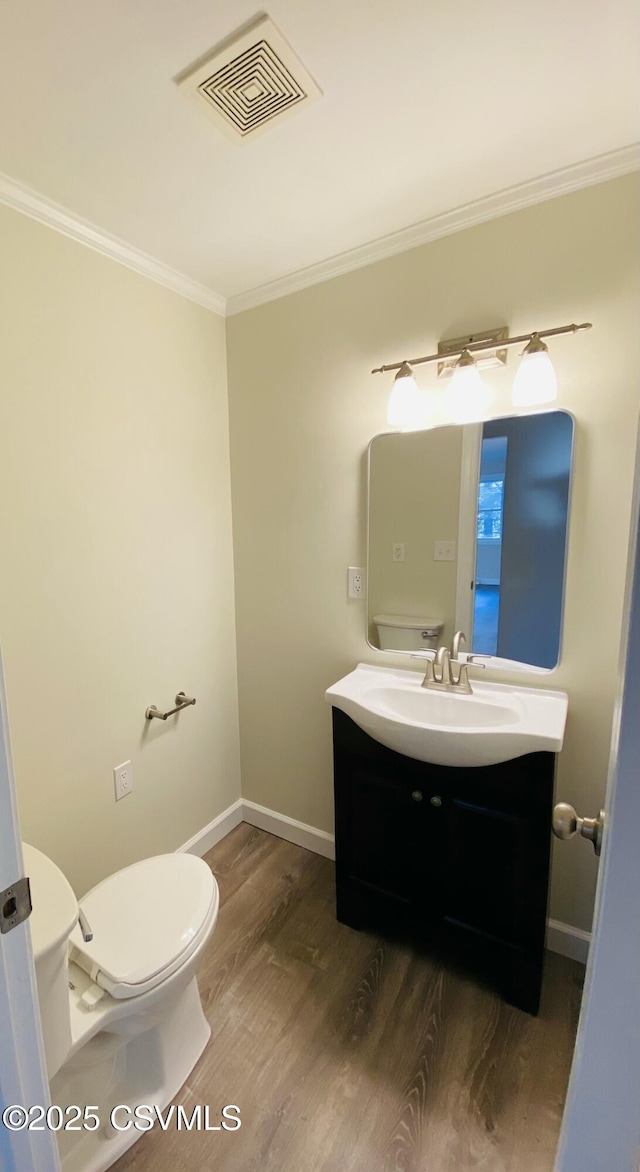 bathroom featuring ornamental molding, visible vents, vanity, and toilet