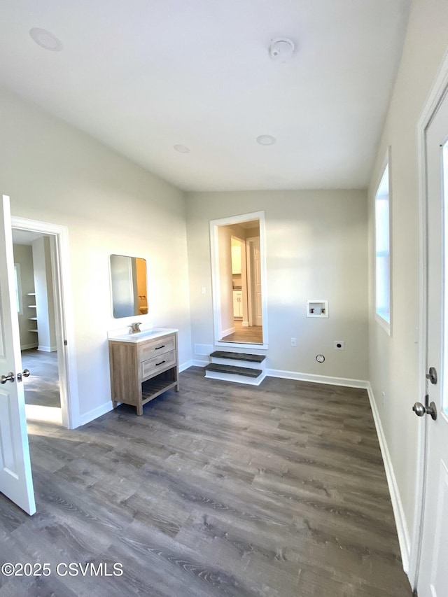 unfurnished bedroom featuring dark wood-style flooring and baseboards