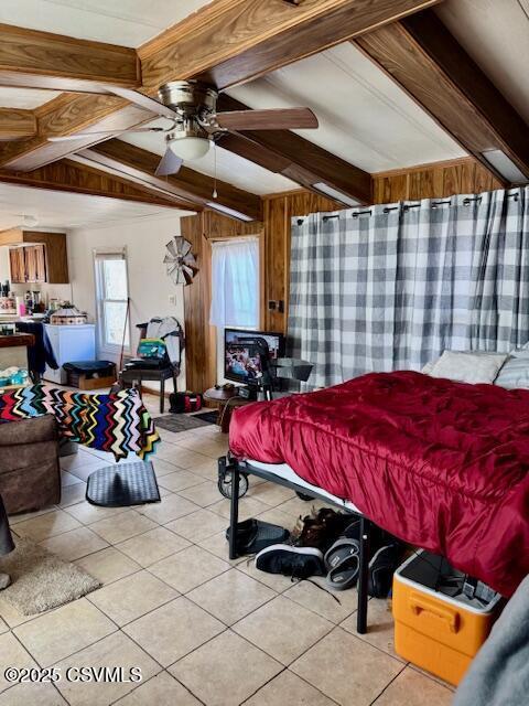 bedroom featuring light tile patterned flooring, beamed ceiling, and wooden walls