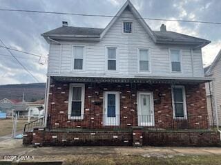 view of front of property with covered porch and brick siding