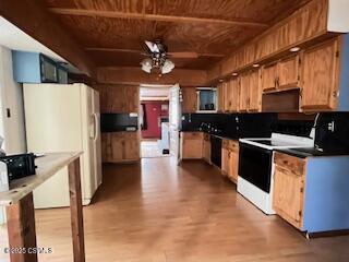 kitchen featuring a ceiling fan, white appliances, wooden ceiling, and wood finished floors