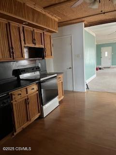 kitchen featuring black microwave, range with electric cooktop, brown cabinets, dishwasher, and dark countertops