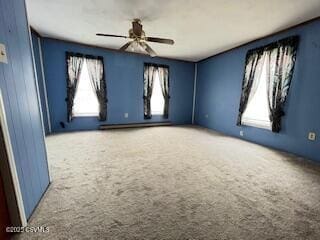 carpeted spare room featuring a ceiling fan