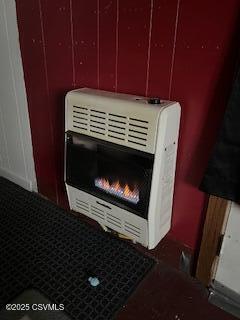 interior details featuring a glass covered fireplace and heating unit