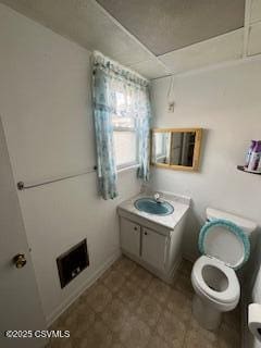 bathroom featuring toilet and vanity