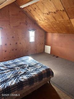 unfurnished bedroom featuring lofted ceiling and carpet