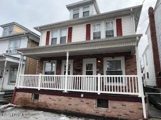 traditional style home featuring covered porch