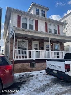 american foursquare style home with a porch