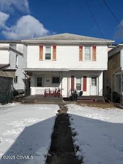 townhome / multi-family property featuring a porch