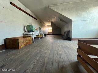 bonus room featuring lofted ceiling and wood-type flooring