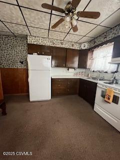 kitchen with a ceiling fan, freestanding refrigerator, light countertops, and dark brown cabinetry