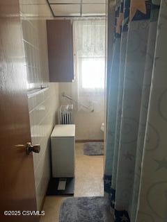 bathroom with radiator heating unit and walk in shower