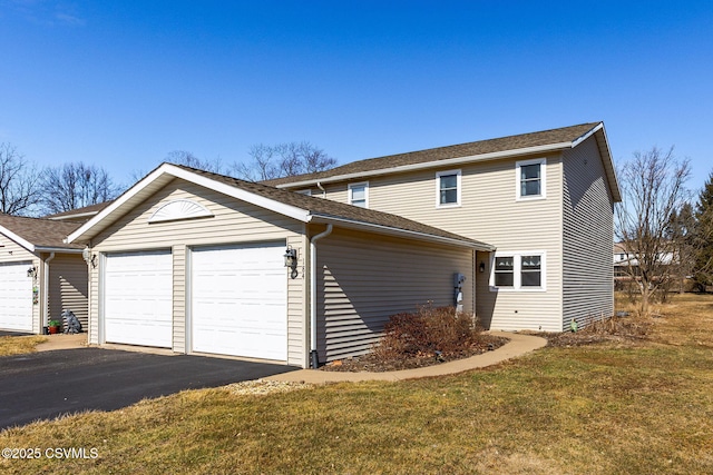 view of front facade with a garage and a front lawn