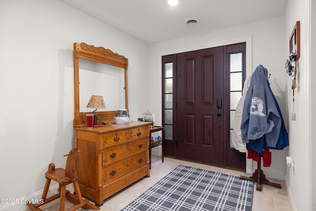 entryway featuring light tile patterned floors, visible vents, and baseboards