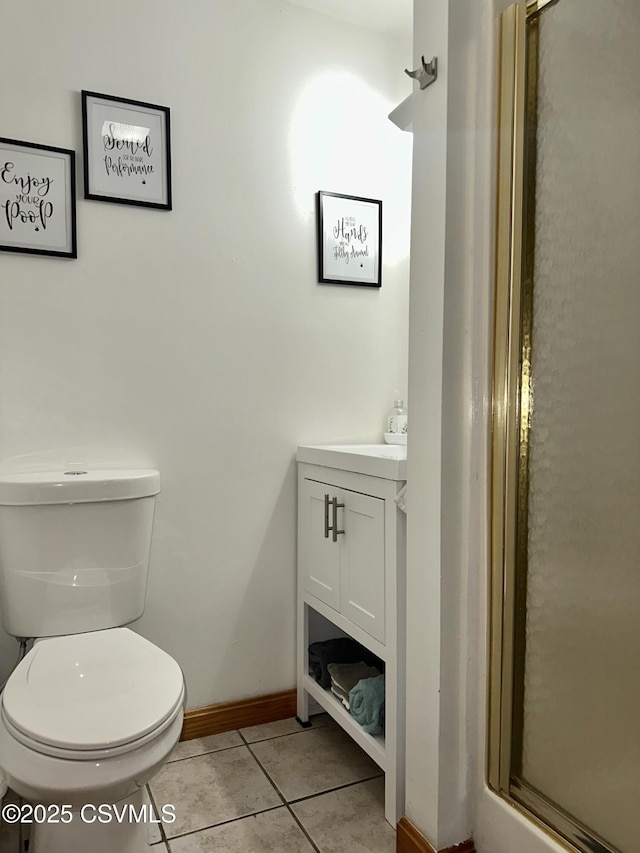 bathroom with vanity, a stall shower, tile patterned flooring, and toilet