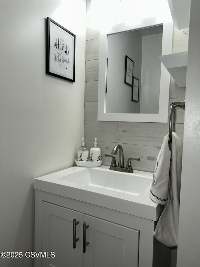 bathroom with tasteful backsplash and vanity