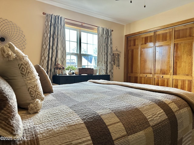 bedroom with ornamental molding and a closet